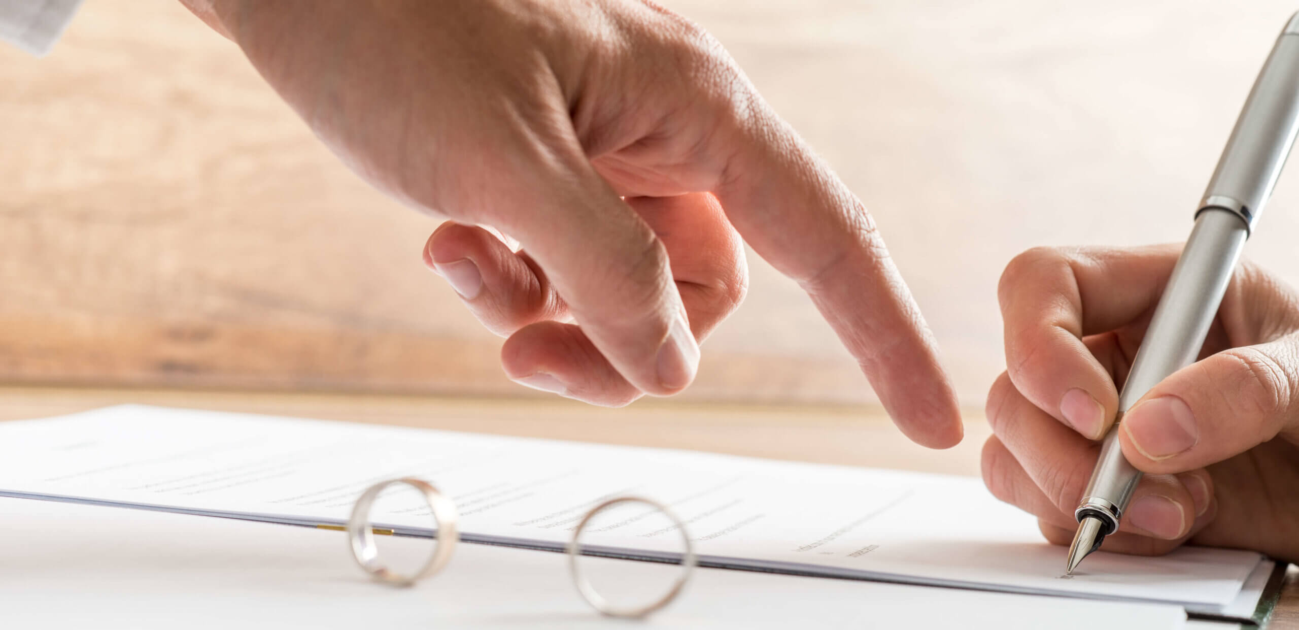 Male hand pointing to a divorce paper