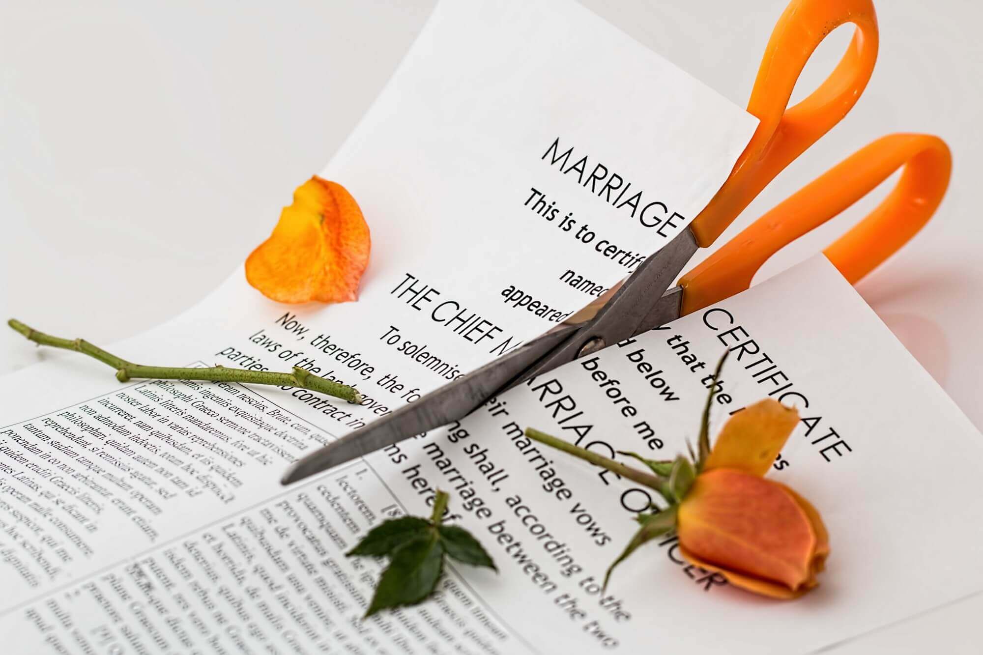 Marriage papers being cut by scissors